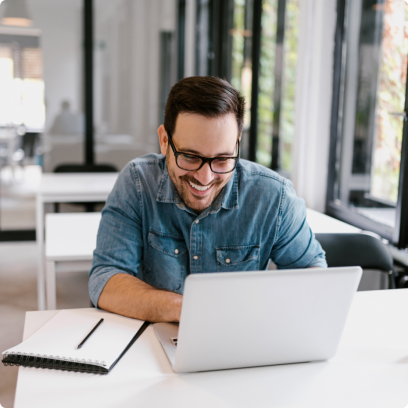 Man working on a laptop, focused and engaged in his task