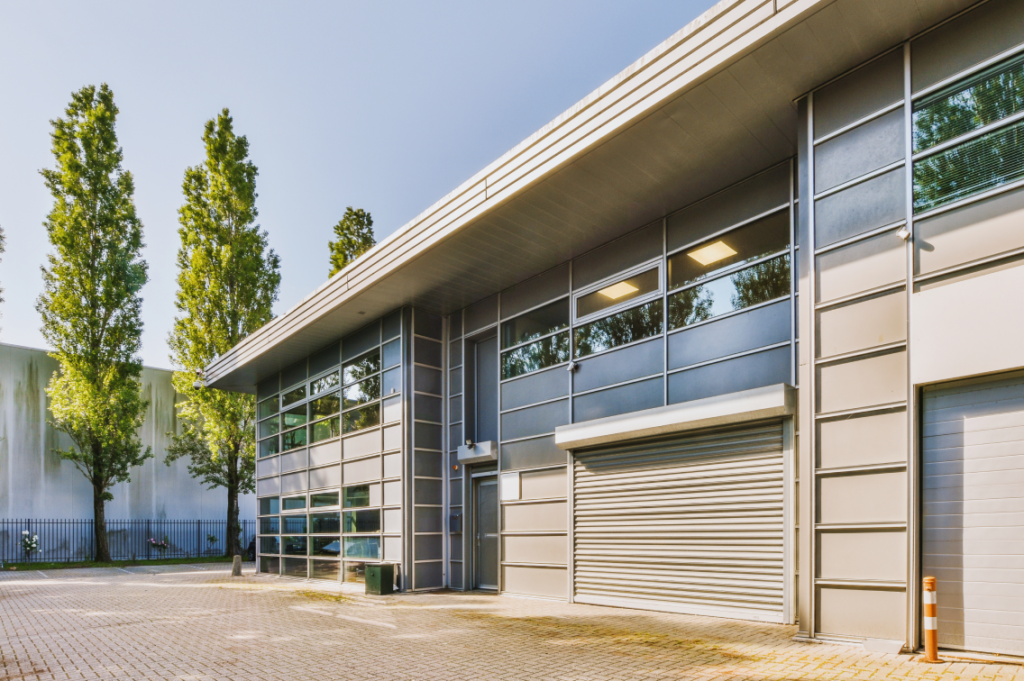 Modern commercial building surrounded by lush green trees, creating a welcoming environment